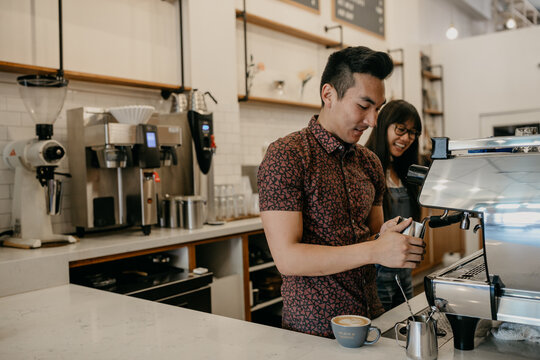 Barista Making Latte in Coffee Shop