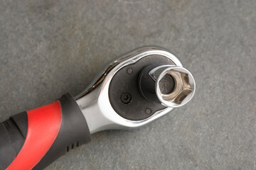 Small ratchet with rubber handle.
