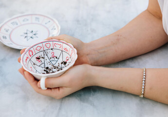 Woman fortune teller reading tea leaves