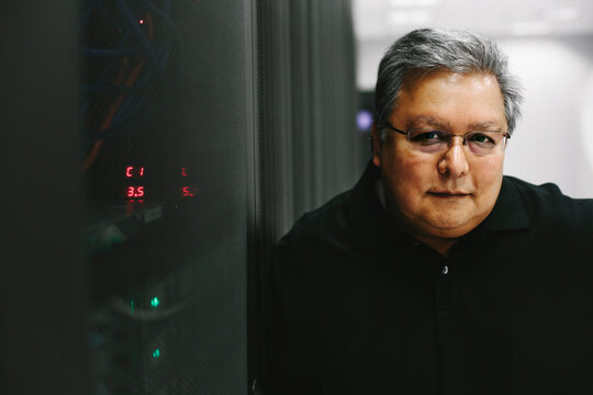 Professional IT computer expert next to computer servers
