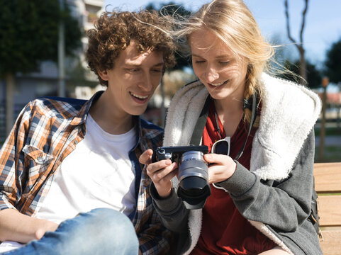 Woman showing shots to man