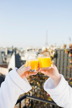 Female friends drinking orange juice on the terrace