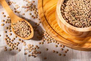 Uncooked dried lentils in a wooden bowl - Lens culinaris