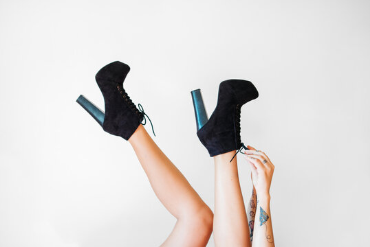 Woman legs with high-heeled ankle boots