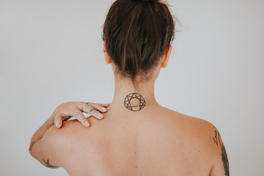 Back of woman with tattoo on the neck