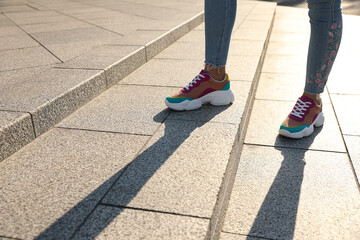 Woman on stairs outdoors, closeup with space for text. Choosing way concept.