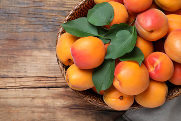 Fototapeta na wymiar Delicious fresh ripe apricots on wooden table, top view