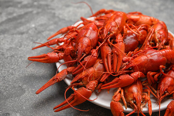 Delicious boiled crayfishes on grey table, closeup