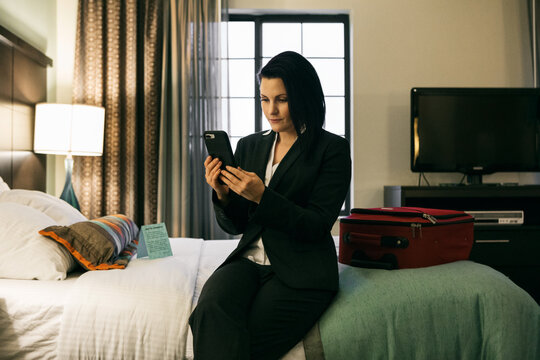 Business: Woman Checks Text Messages After Arrival