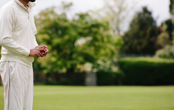 Anonymous detail of a cricketer with cricket ball
