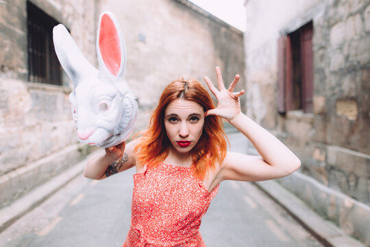 woman joking with a bunny mask