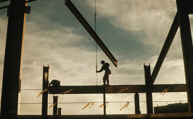 Lone Construction Worker Standing on Beam at Construction Site