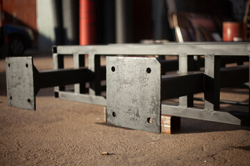 The metal structure lies on the street. Preparing a large advertising stand.