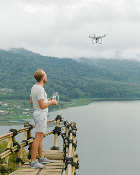 Man with dron on pier