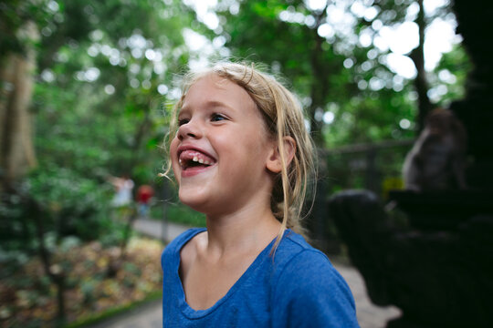 Laughing girl with toothless smile