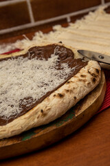 Chocolate pizza and grated coconut
