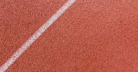 Foto auf Alu-Dibond White painted line on tartan ground track in a athleticism and sports field.  © Sondem