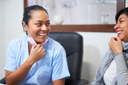 Friendly dentist enjoying herself with a smiling patient