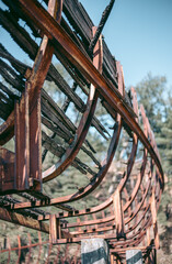 Old abandoned wooden bobsleigh track in summer by daylight