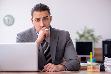 Young male employee working in the office