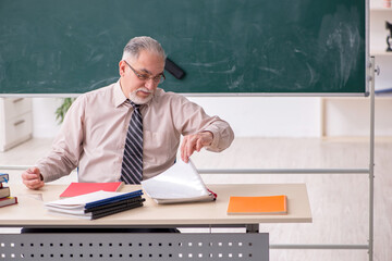 Old male teacher in the classroom