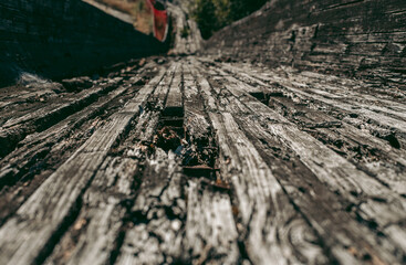 Old abandoned wooden bobsleigh track in summer by daylight