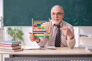 Old male teacher in the classroom