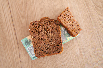 Fototapeta na wymiar Australian dollar banknotes and slices of bread