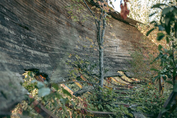 Old abandoned wooden bobsleigh track in summer by daylight