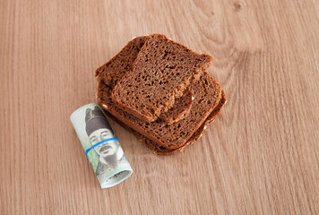 A roll of Korean won banknotes and black bread
