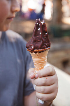 Boy / youth holding and choc top soft serve icecream