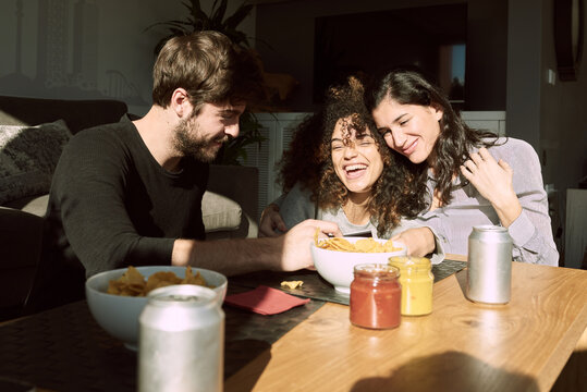 Lovely moment of girlfriends and his friend laughing at polaroid
