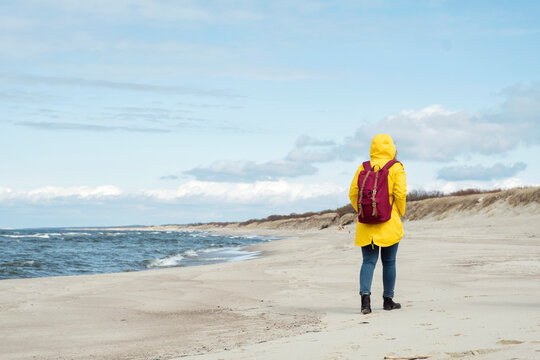 Woman with backpack on coast