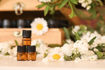 Image of 3 1ml amber essential oil sample vials in front of wooden box with white flowers