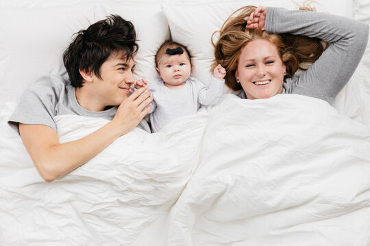 Family in bed with baby