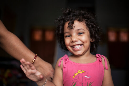 Little kid looking at camera and smiling