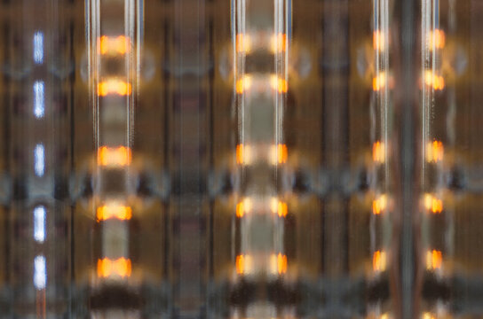 Closeup of patterns in a room viewed through a glass brick in a wall