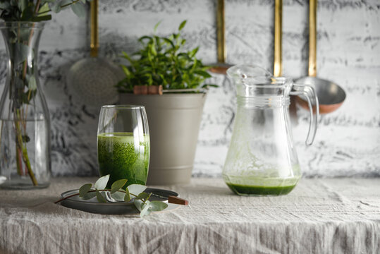 Fresh green juice drink in a glass on a table.