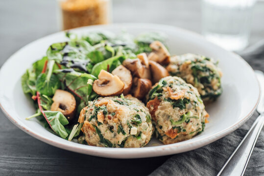 Food: Spinach Dumplings with salad and fried mushrooms, vegan