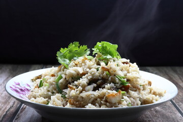 Traditional fried rice with chilly and dried fish, sliced shallot and topping with fresh coriander on the plate. Famous spicy street food menu in Asia.
