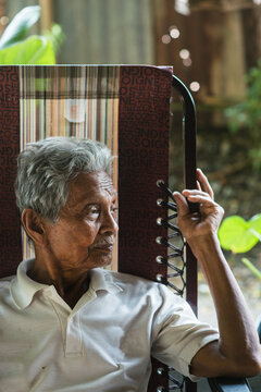 Asian old man sitting on chair