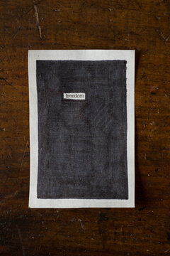 Piece of Paper with ""freedom"" blacked out on it