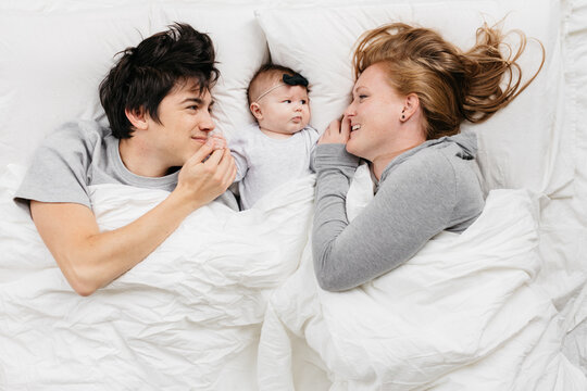 Family in bed with baby