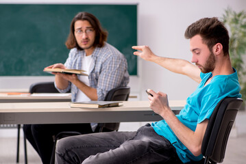 Two male pupils in bullying concept in the classroom