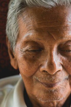 Asian old man sitting on chair