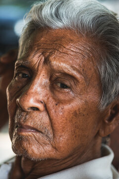 Asian old man sitting on chair