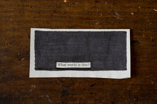 Piece of Paper with ""what world is this?"" blacked out on it