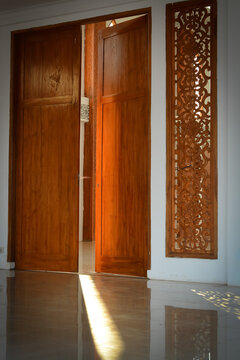 Wooden door in mosque with beautiful carved and sunrays. 