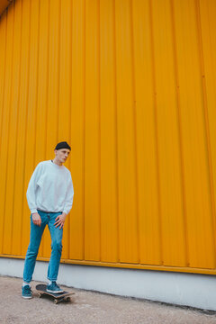 Portrait of young hip adoslecent guy /skinhead/punk subculture.