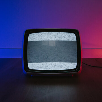 vintage television on a blue/red iluminated room